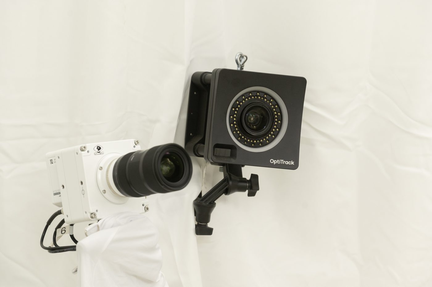 Close-up of the OptiTrack motion-capture cameras lining the CALI flight hall.