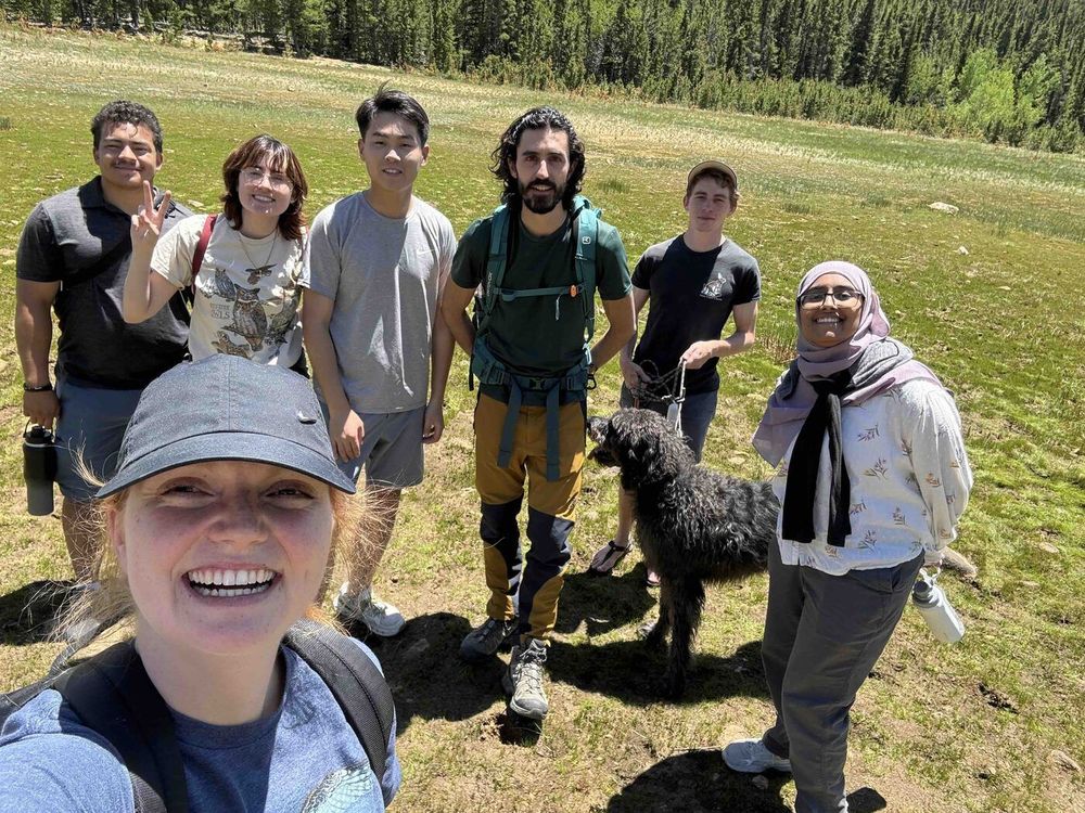 The BIRD Lab group standing in an open field with Christina taking a selfie
